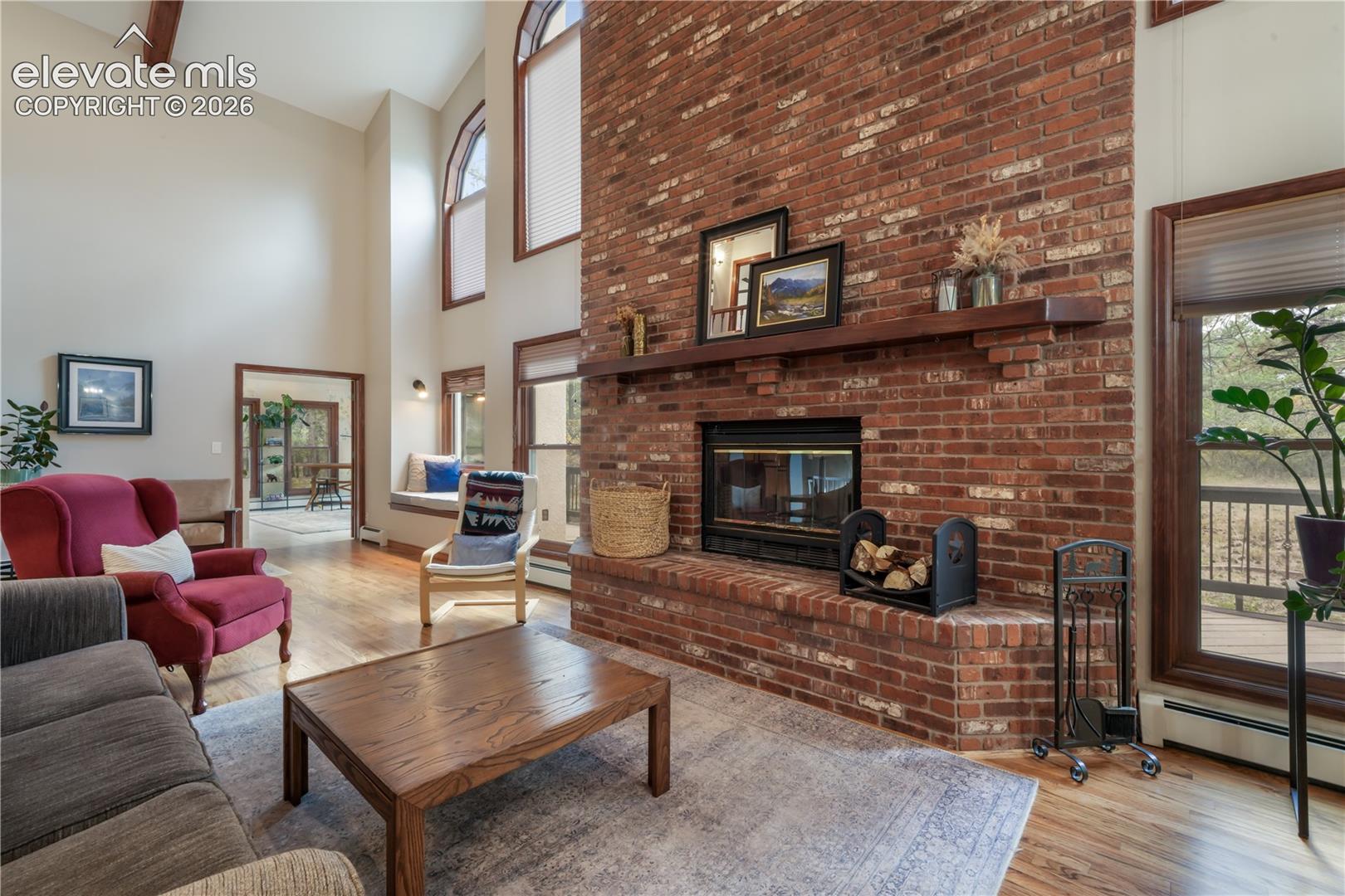 Family room with wood burning fireplace and brick surround floor to ceiling