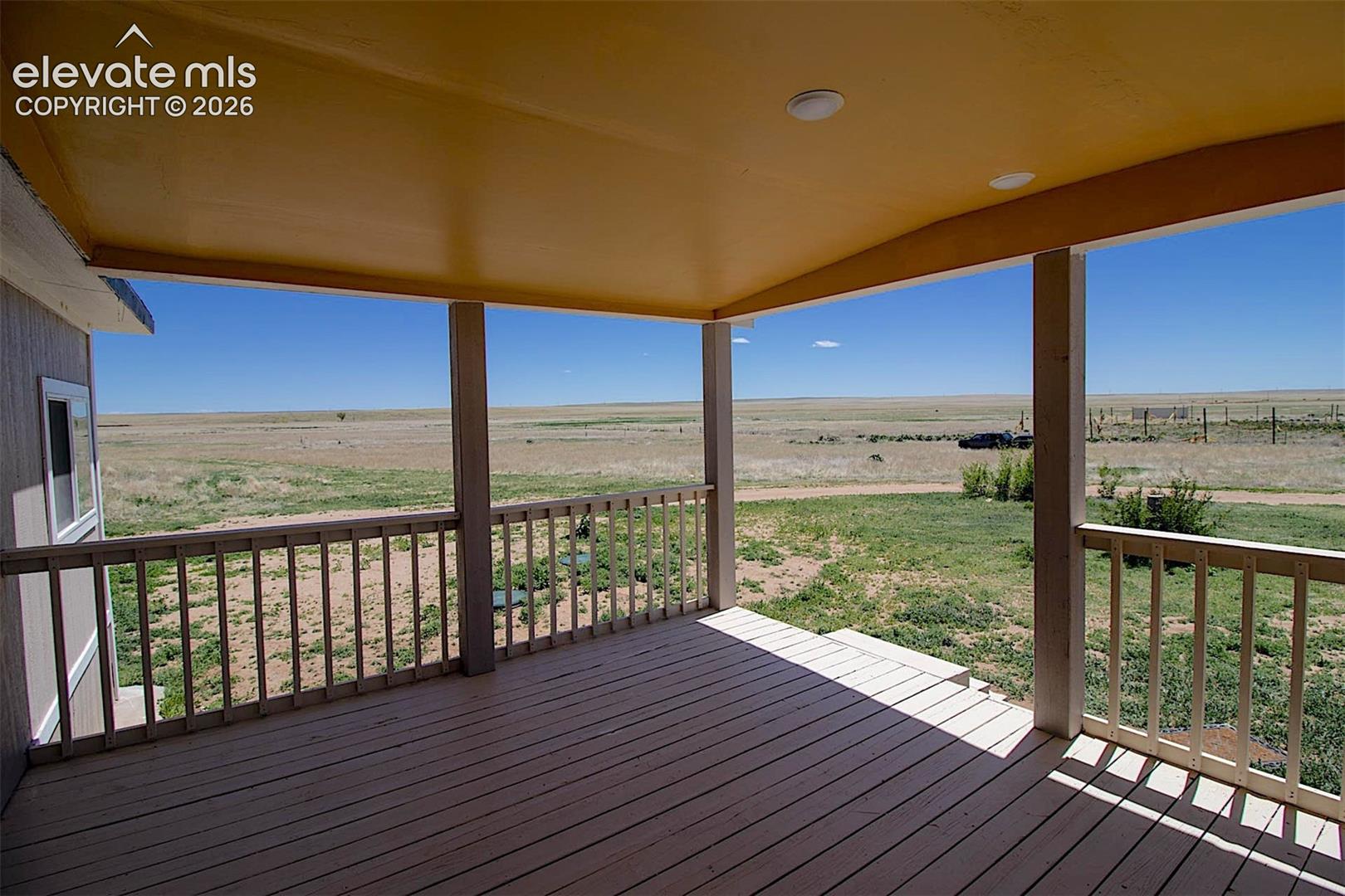 Wooden terrace featuring a rural view