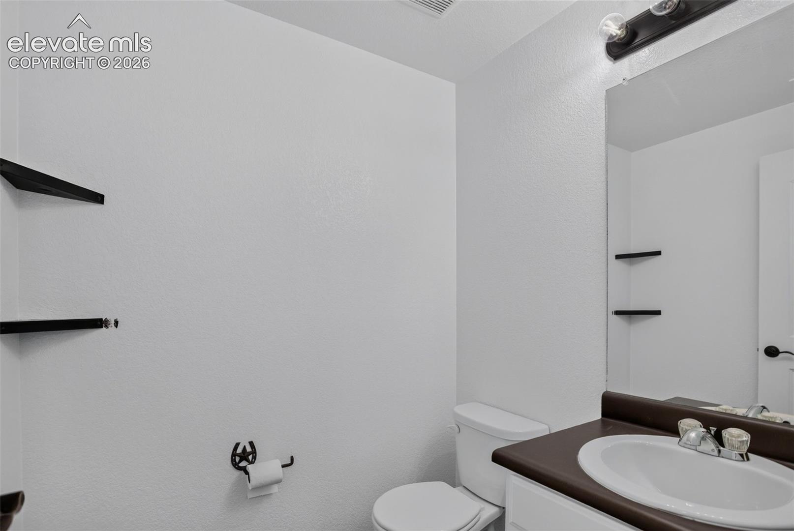 Bathroom vanity with an integrated sink and a dark countertop