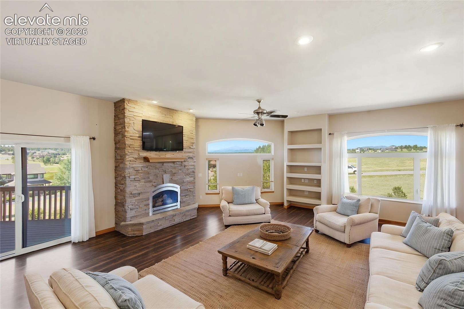 Inviting Living Room with Pikes Peak views (virtually staged)