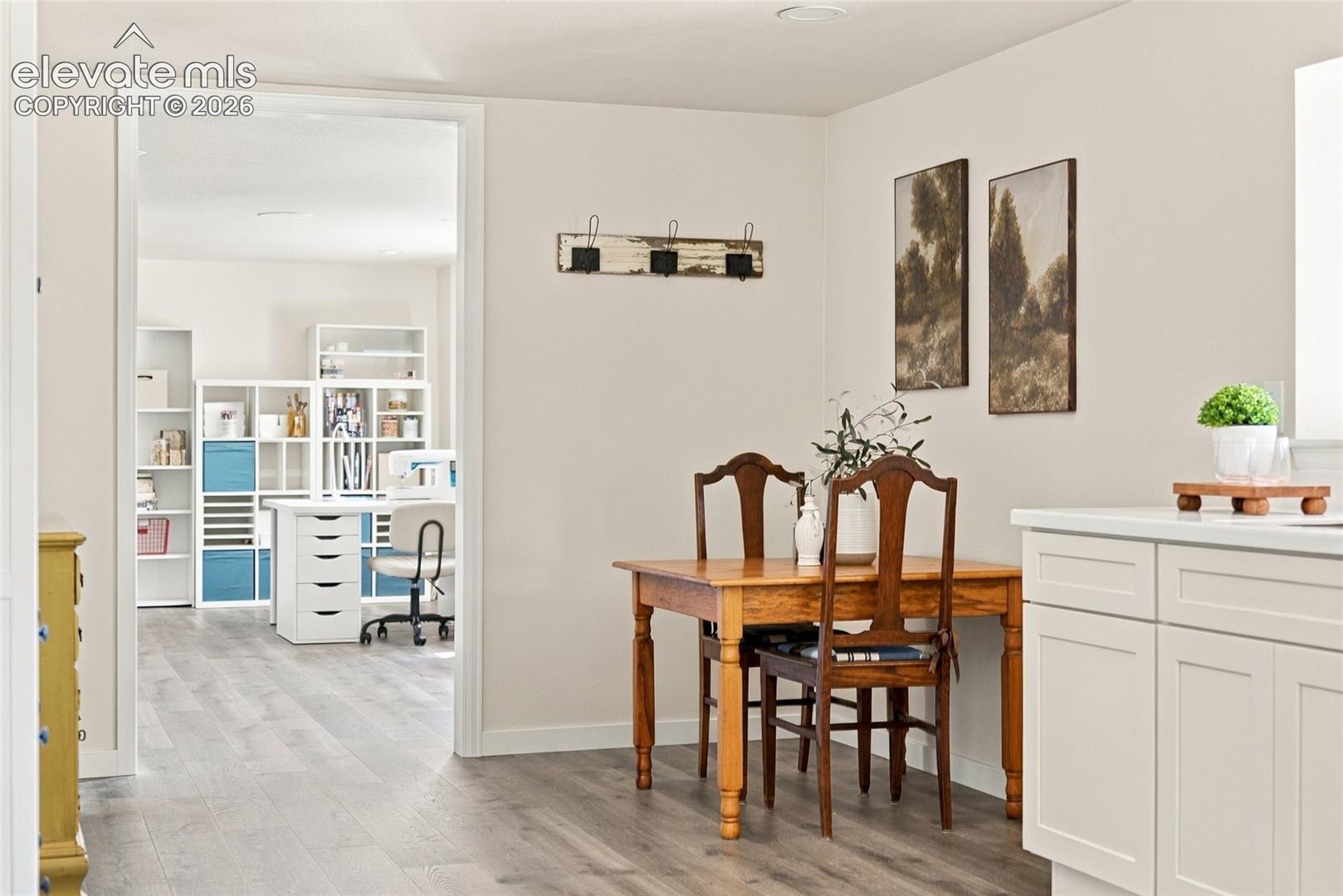 Basement Light-toned walls complement wood-finish flooring throughout