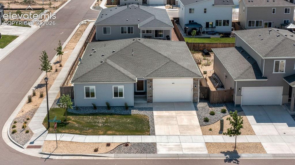 Single-story residence featuring a light gray exterior with stone accents and a dark roof