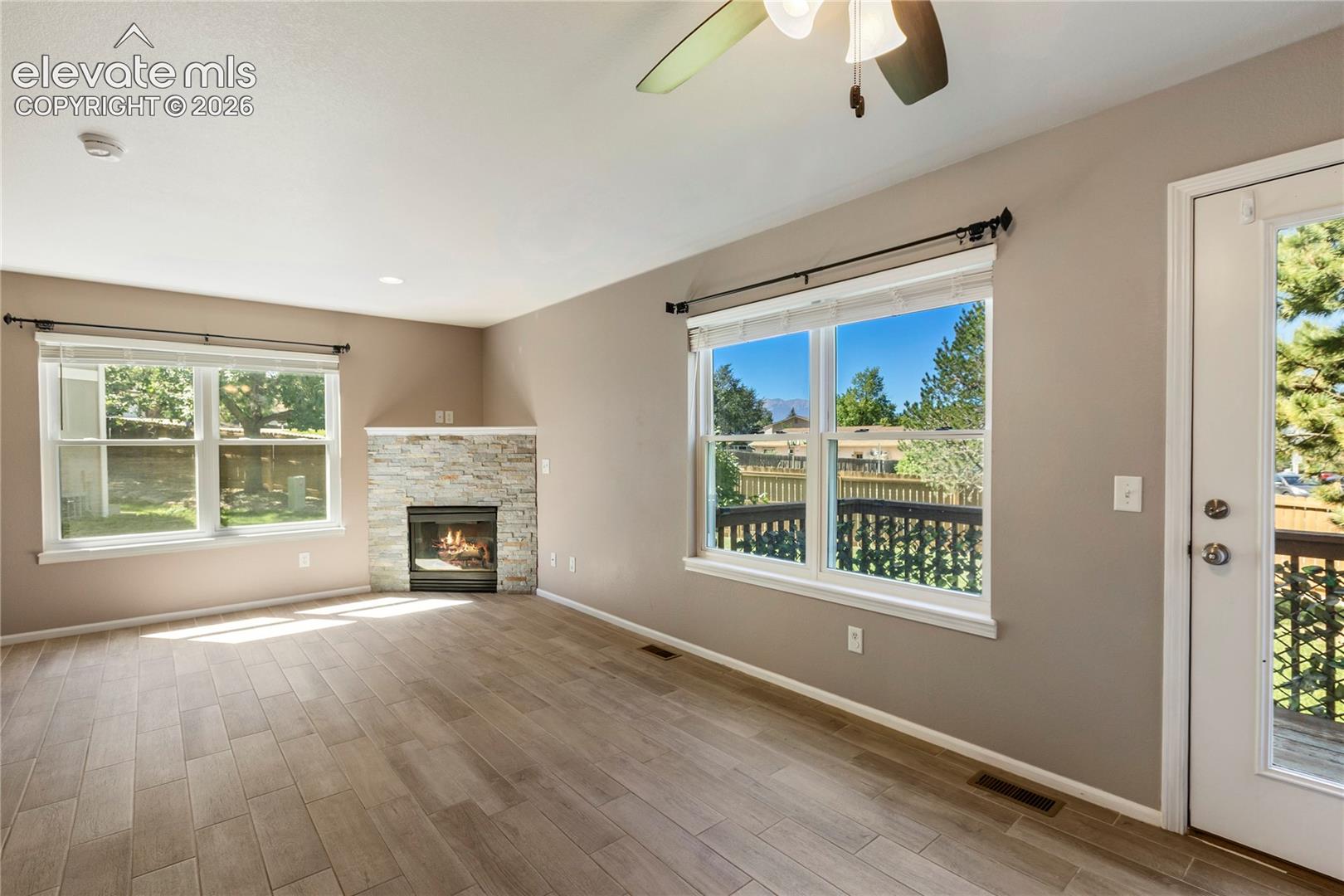New floors and stacked stone on fireplace. Walks out to back deck.
