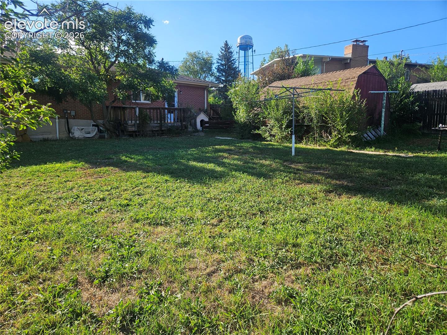 Expansive backyard and wood storage shed