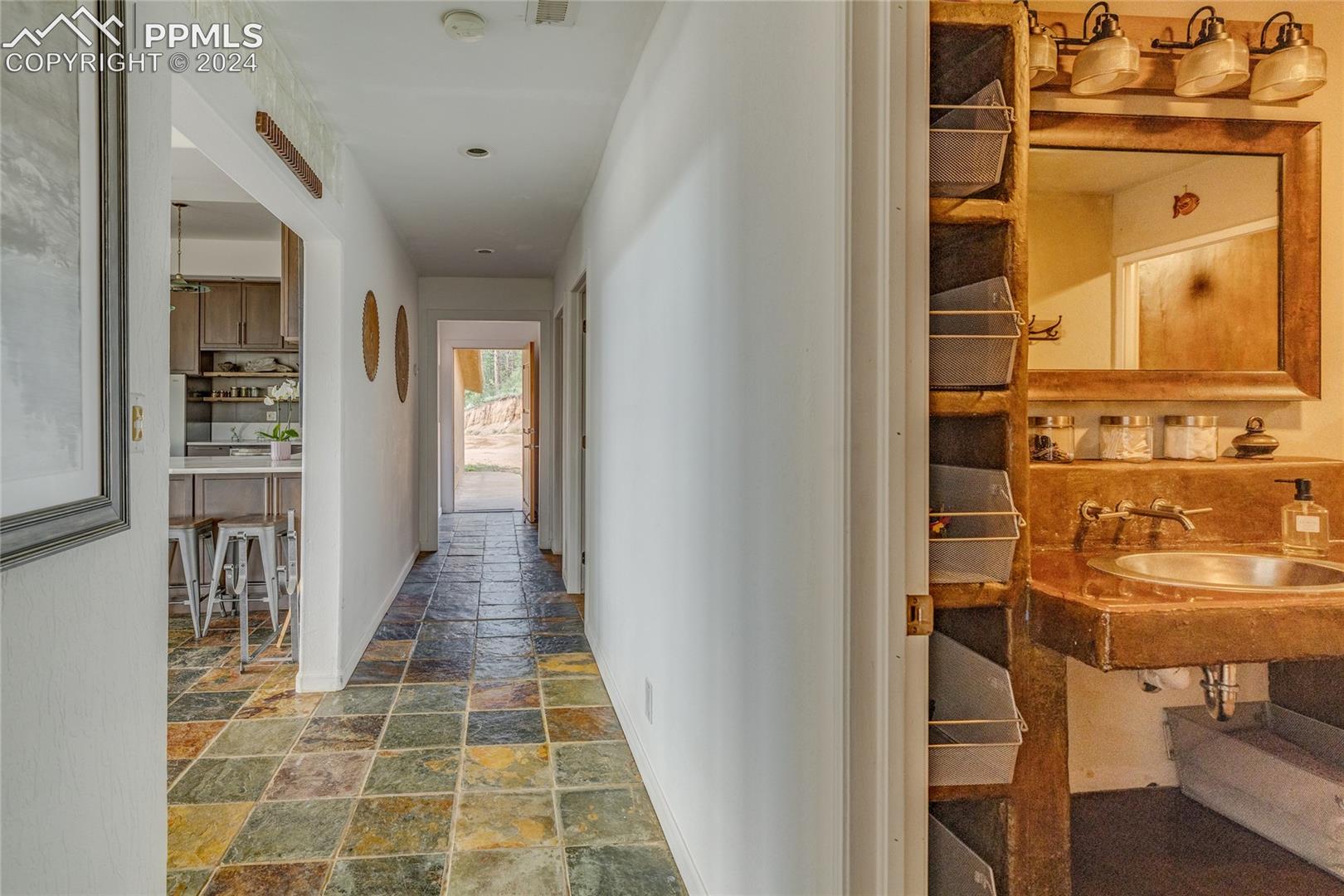 Corridor featuring tile floors and sink