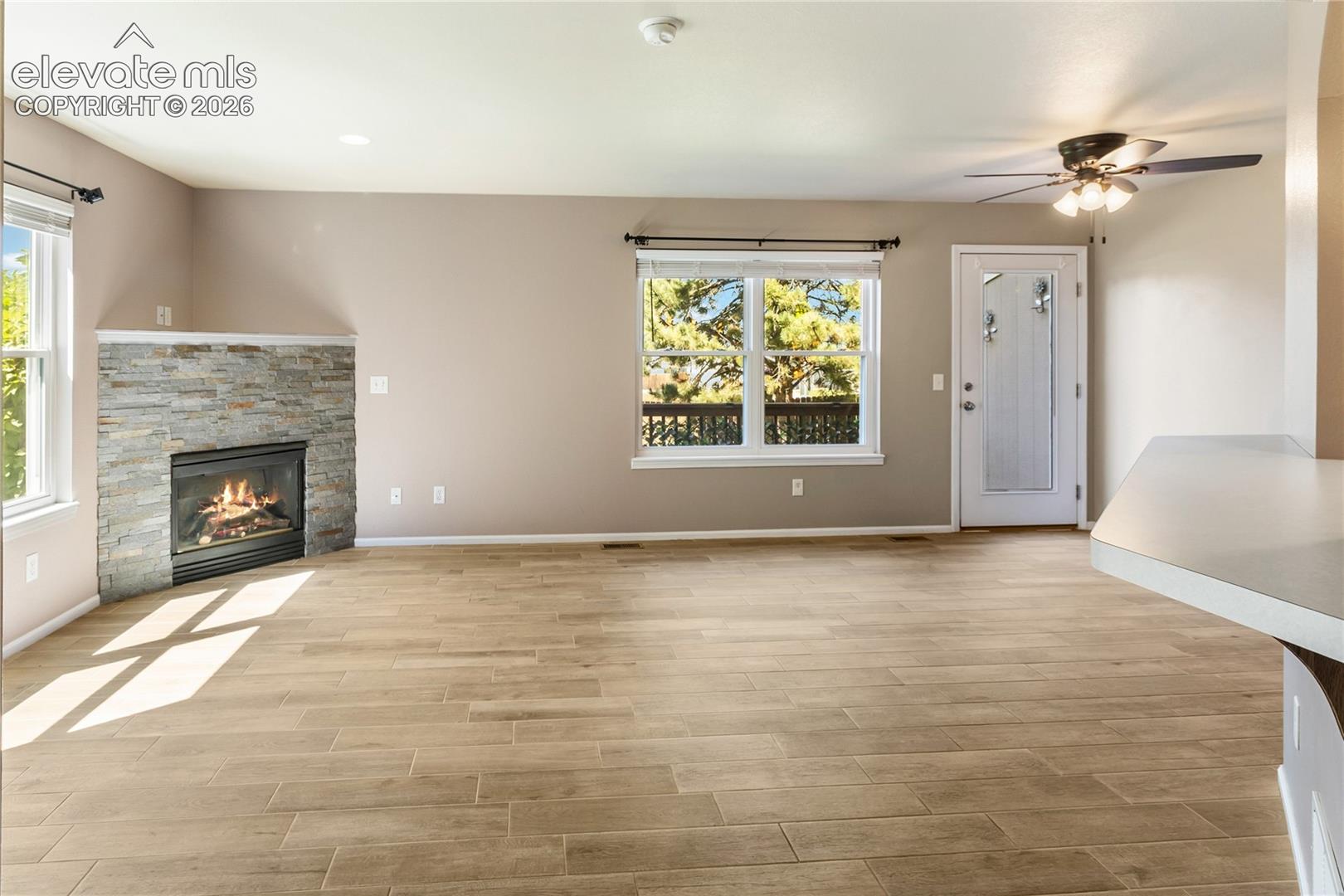 New floors and stacked stone on fireplace. Walks out to back deck.