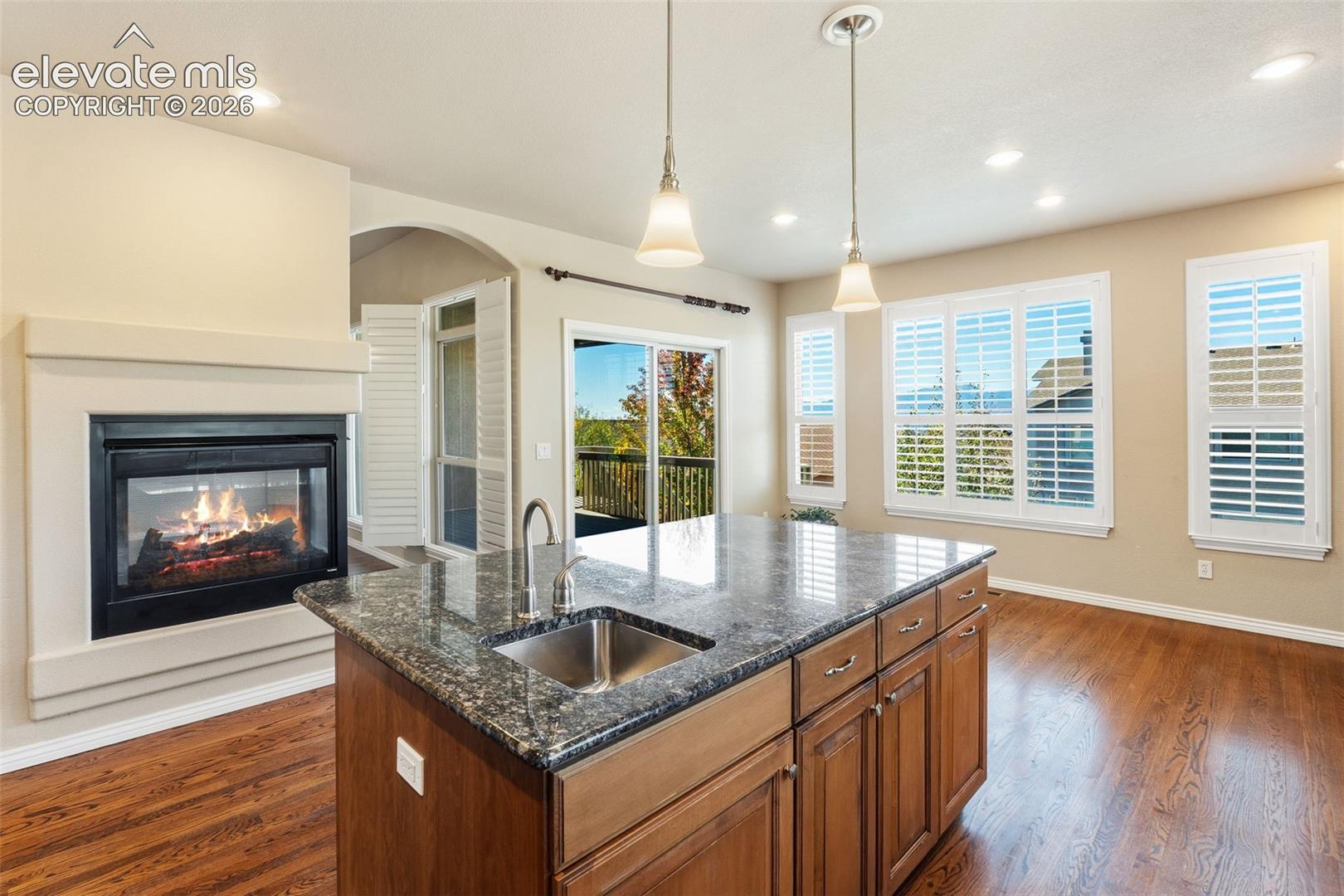 KITCHEN WITH DOUBLE SIDED FIREPLACE & LARGE ISLAND