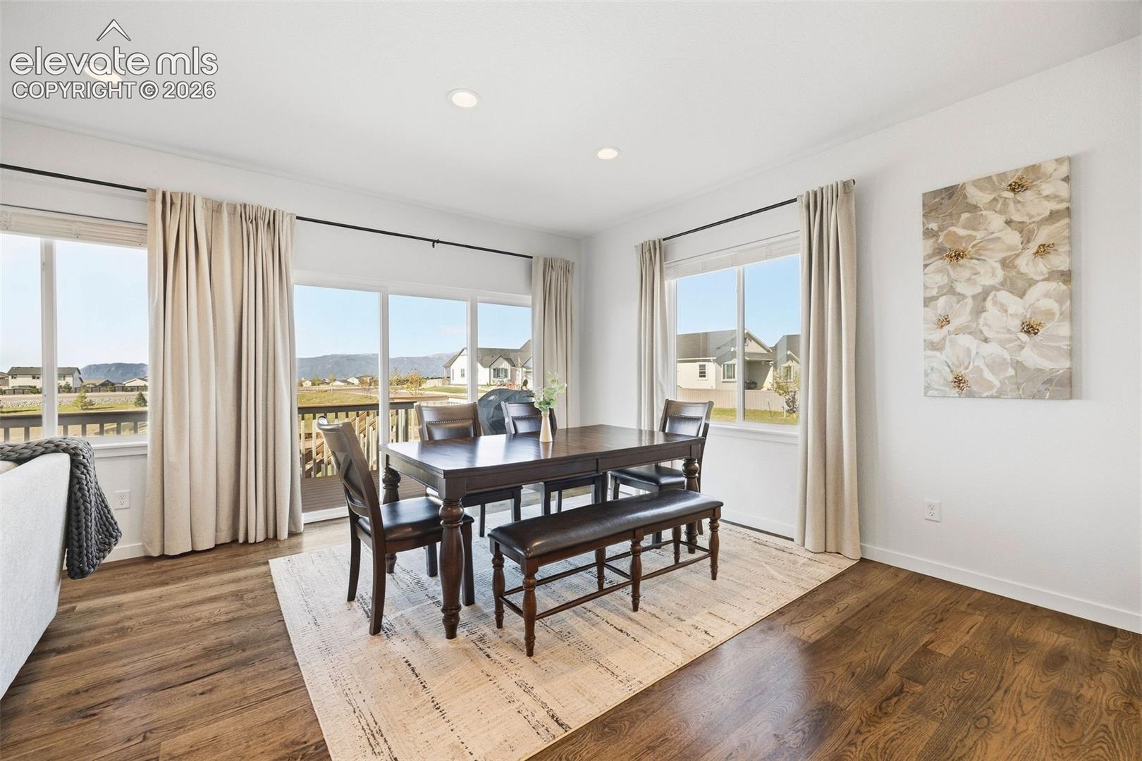 Never miss a sunset. This dining area overlooks the Front Range and has sliding glass doors that walkout to the deck. The green belt behind the home will remain undeveloped - no homes behind you and unobstructed views. 