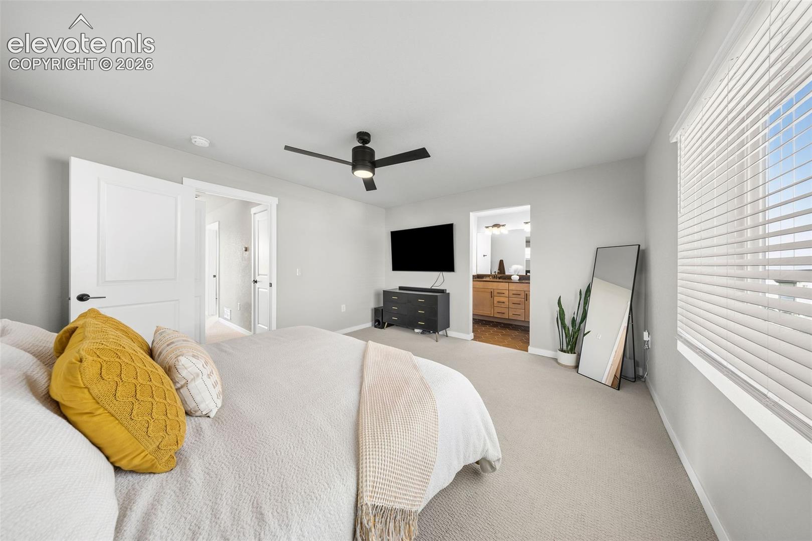 View of the primary bedroom into the ensuite bath