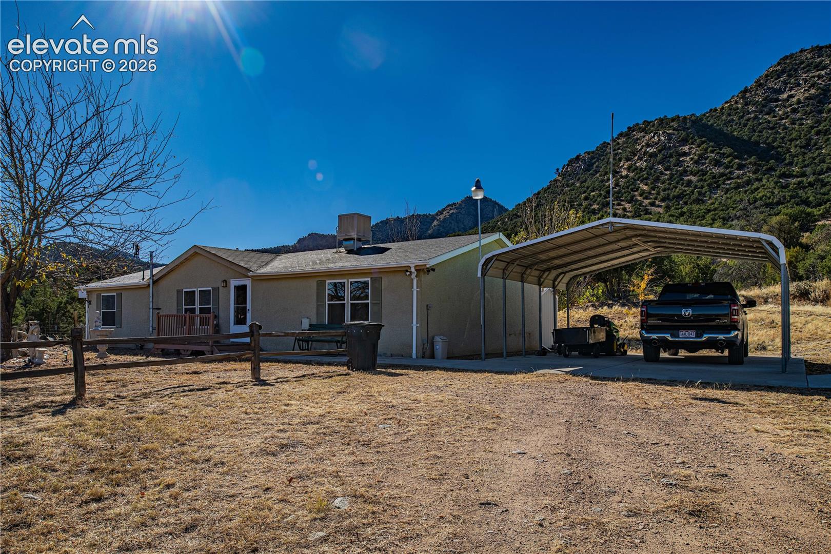 View of front of property featuring a mountain view and a carport