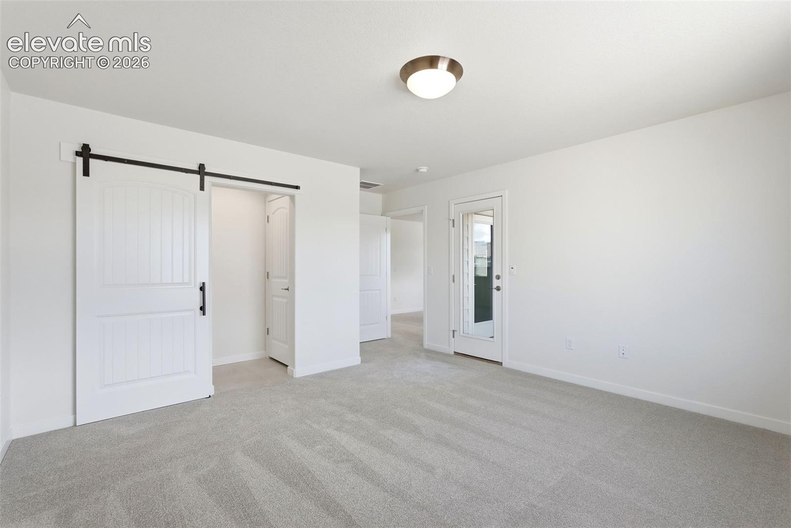 The Primary Bedroom walks out to the Covered Balcony