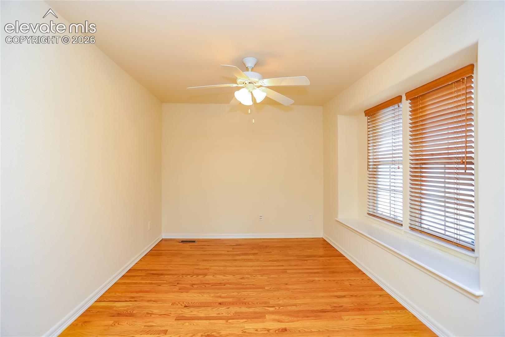 Office is located off the dining area and features hardwood flooring and French doors.