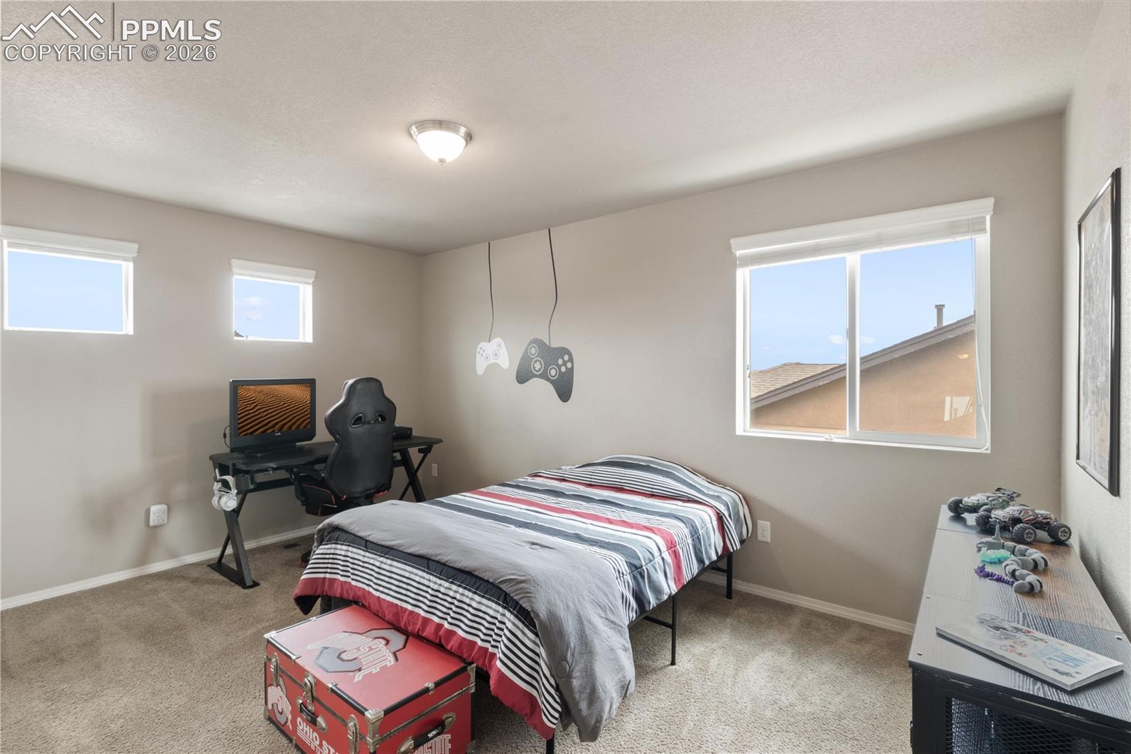 Bedroom with light carpet and baseboards