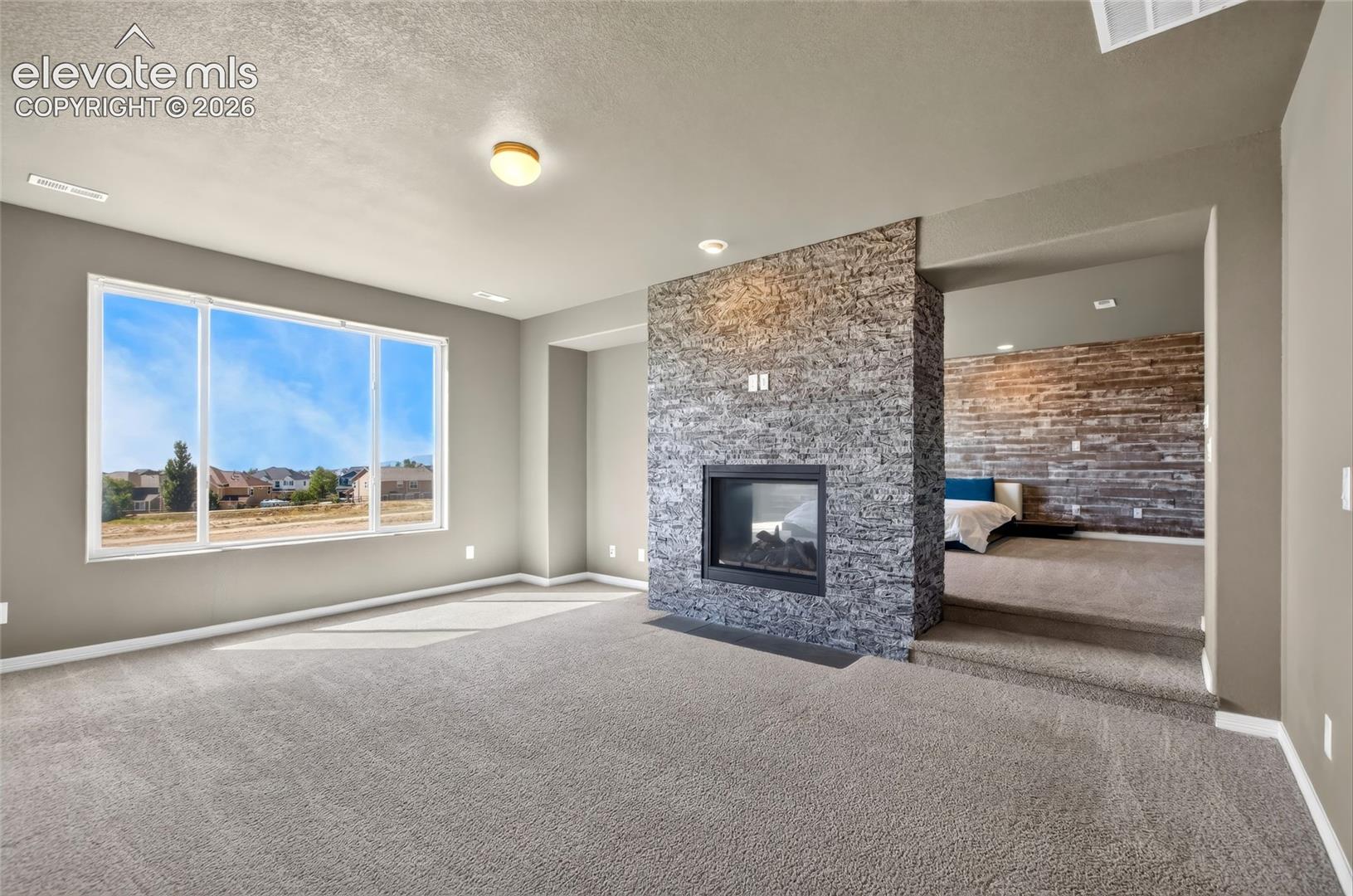 Spacious interior with neutral carpeting