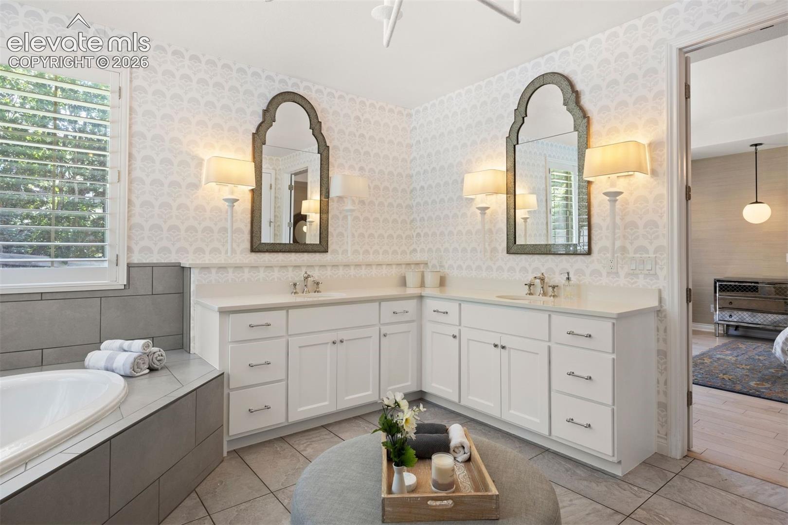 Dual vanity with white cabinetry and countertops
