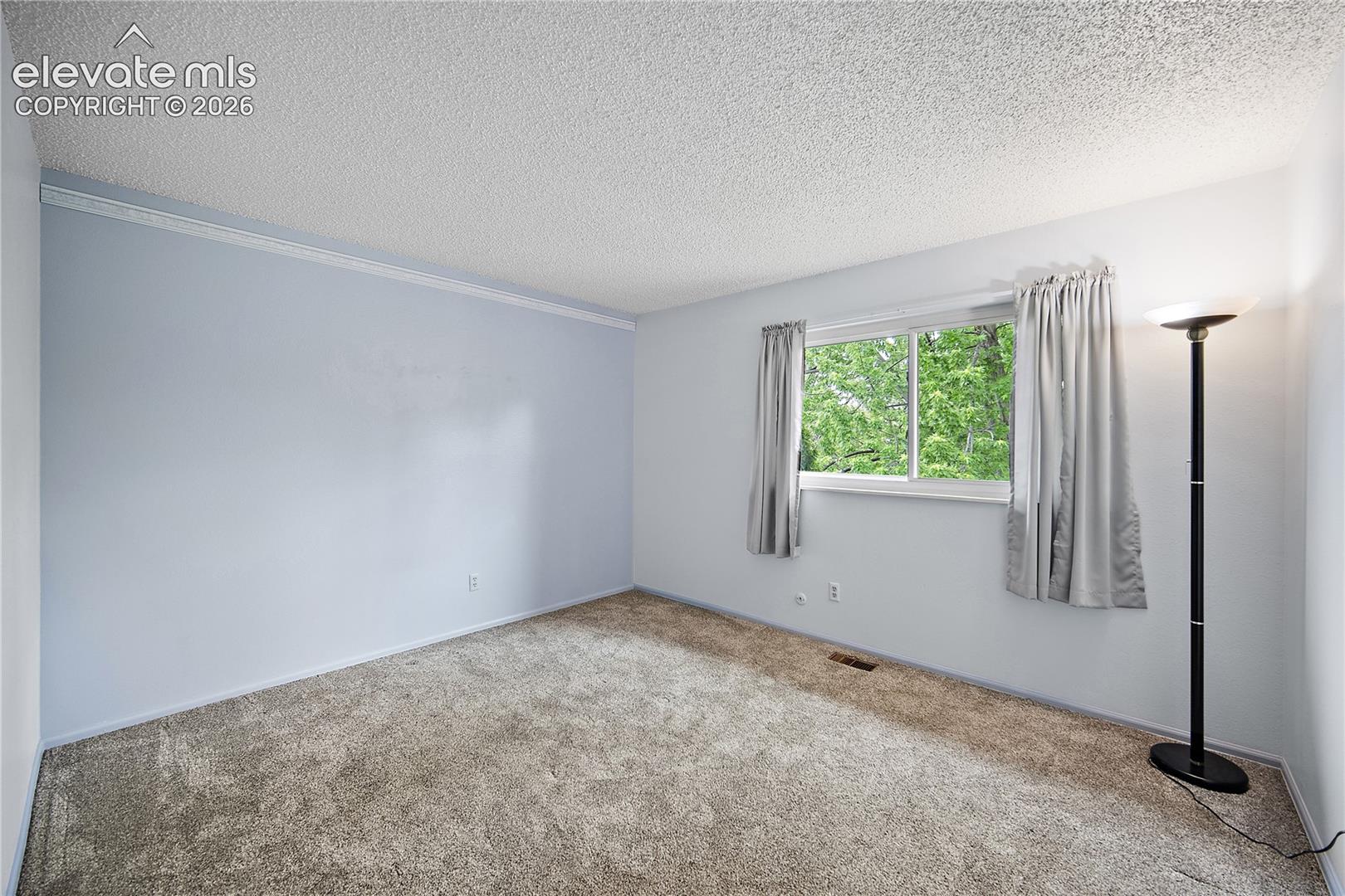 Upstairs bedroom with carpet.