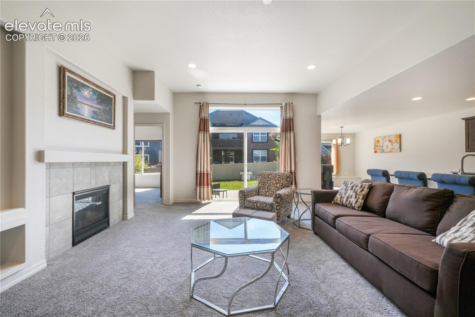 Livingroom with open concept, gas fireplace, large patio sliding doors and new carpet