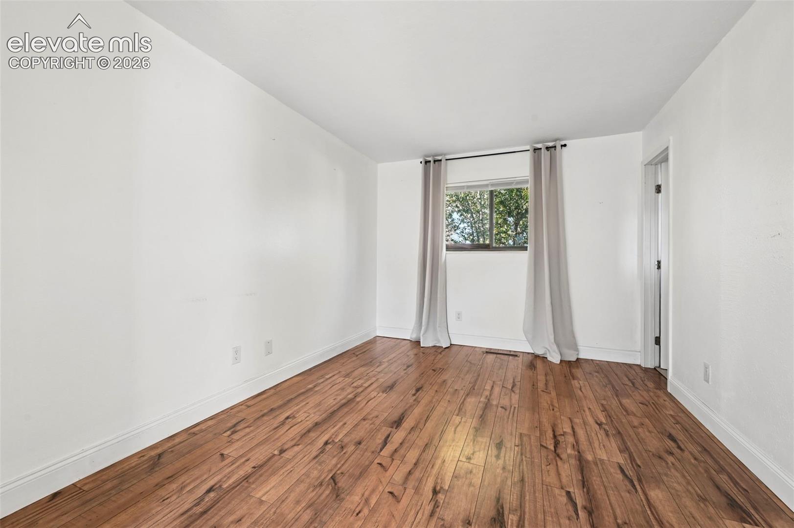 Unstaged primary bedroom with ensuite and separate sitting area with lots of closet space: LVP flooring.
Neutral interior