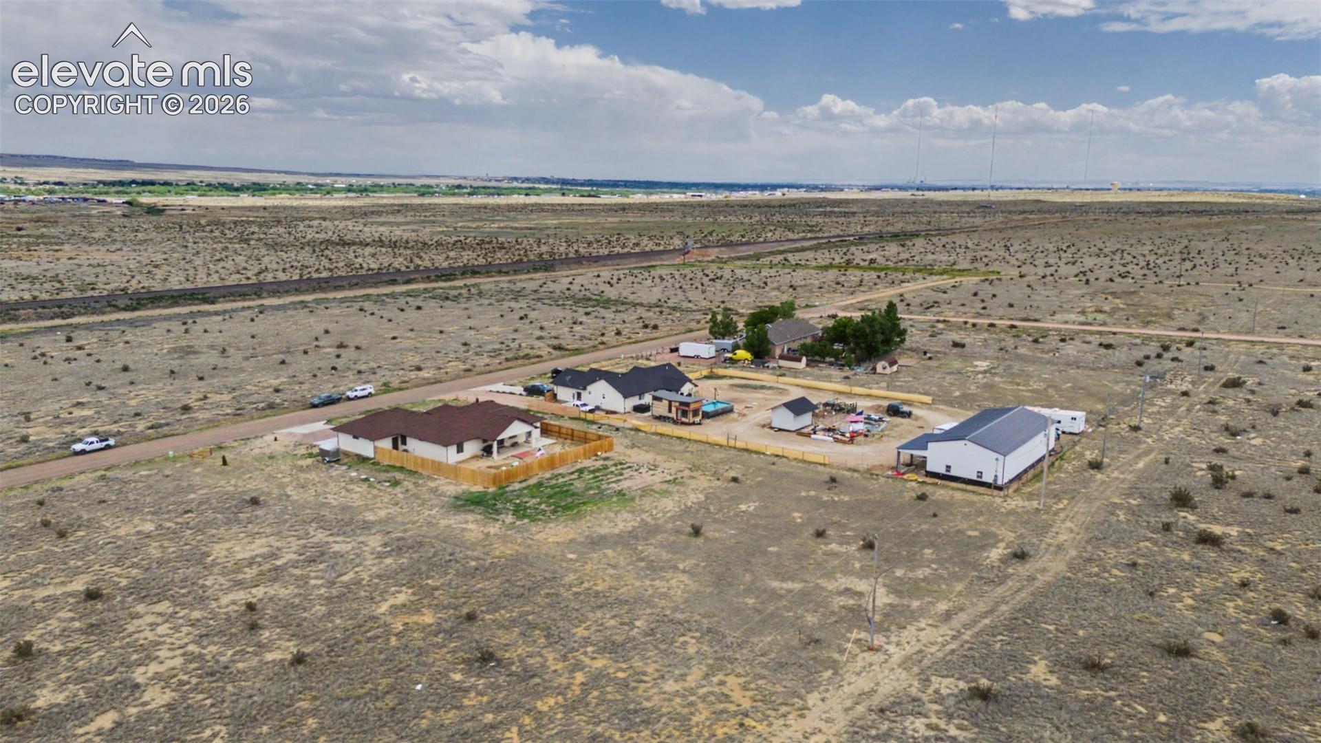 Expansive rural land featuring multiple residential structures and outbuildings