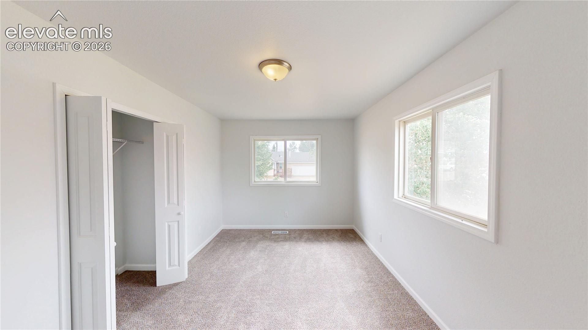 Neutral-toned carpeting with white walls and trim