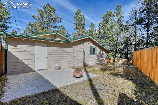 Rear view of house featuring a fenced backyard and a patio area