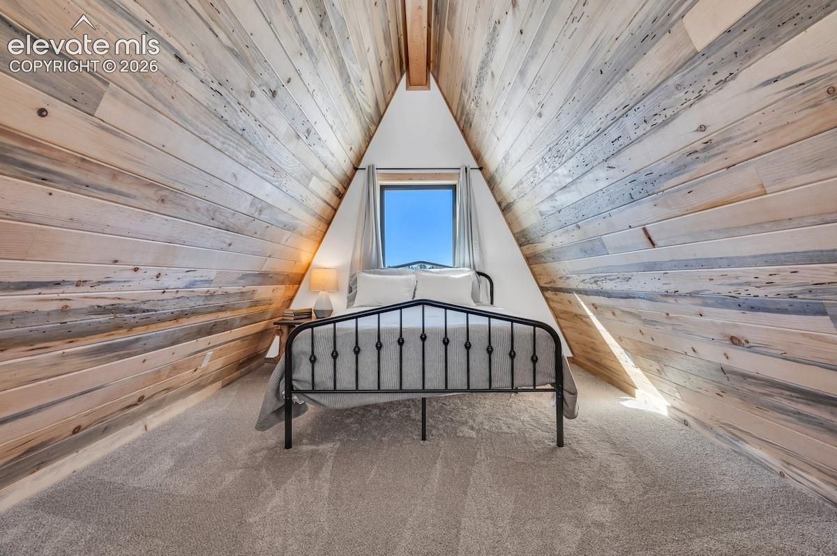 A-frame architecture featuring exposed wood-plank walls and a vaulted ceiling