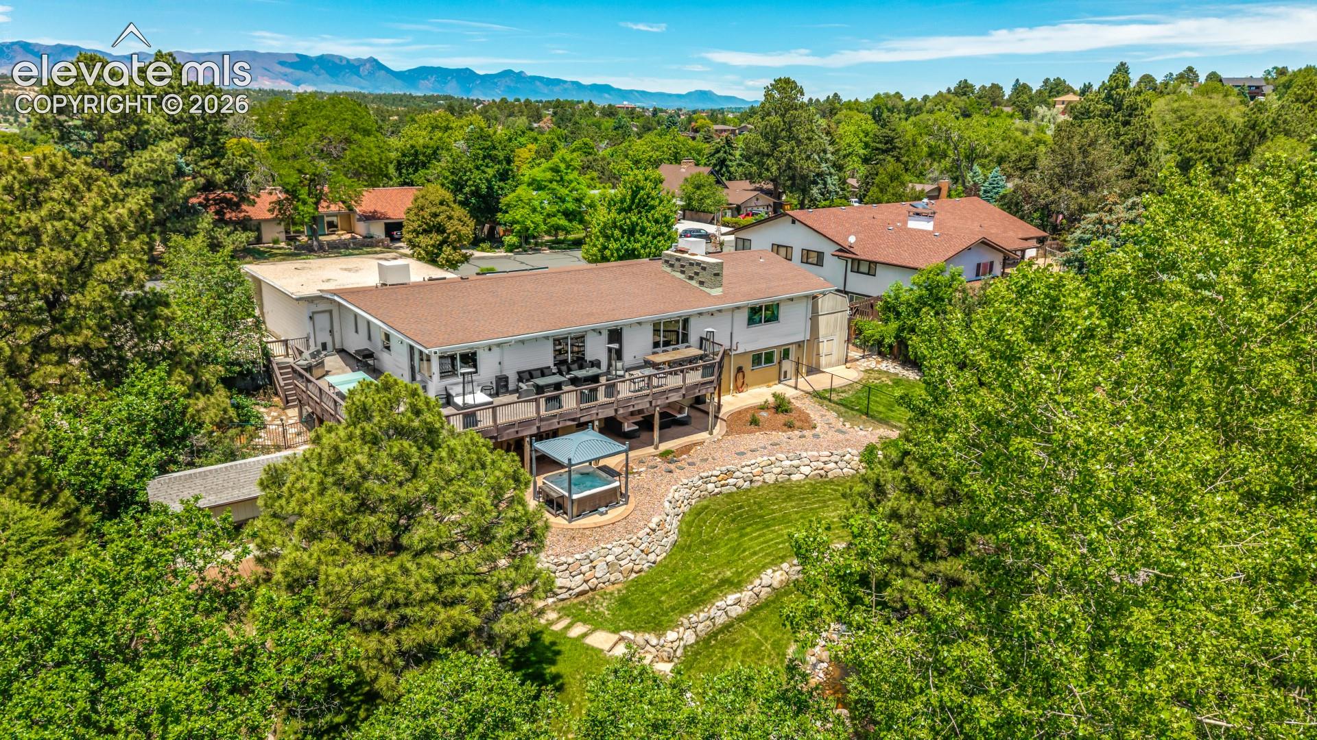 From above, the backyard's terraced lawns, stone walls, and gathering spaces come together as one cohesive outdoor retreat.