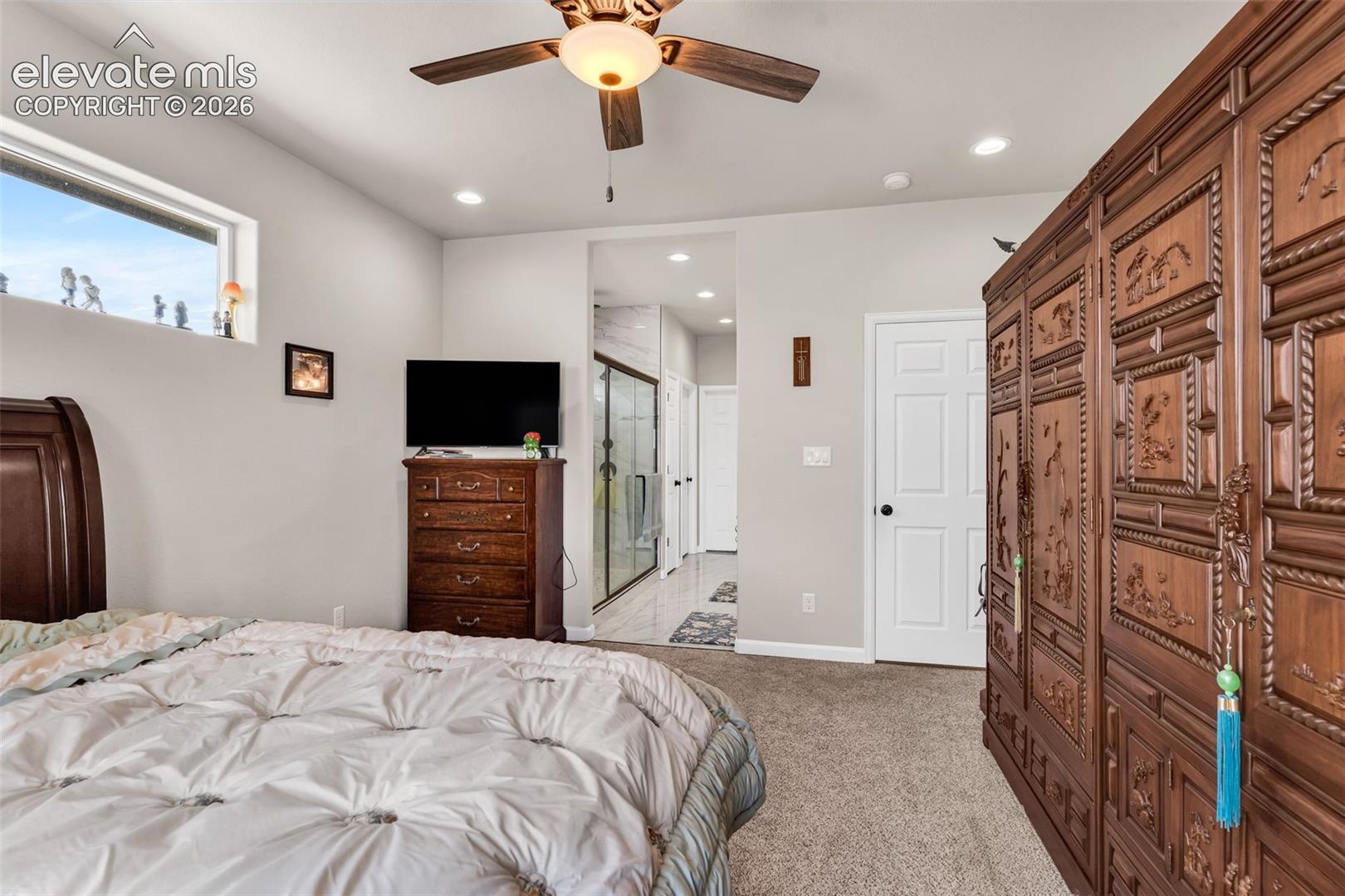 Carpeted bedroom featuring a ceiling fan with light, recessed lighting, and a high-set horizontal window