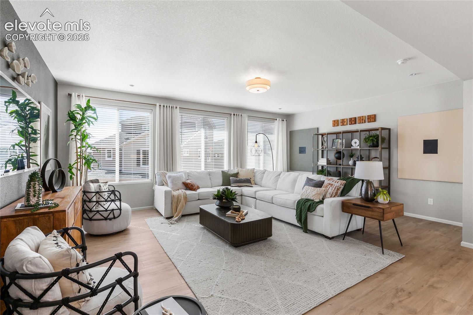 Recessed lighting, wood-finish flooring, multiple windows with blinds, built-in shelving, and a prominent ceiling fixture
*photos of a model home*
