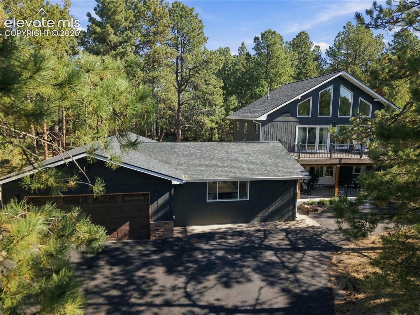 Mature pines create a natural sense of privacy around this completely remodeled Woodmoor home, where approximately 2,900 square feet have been thoughtfully reworked for the way you live now.The kitchen is the room buyers will remember. Generous proportions center around an outstanding island with room to gather, prepare and serve. A distinctive dual-range cooking setup includes two gas ranges one a single oven and the second with double ovens—providing three ovens and exceptional cooking capacity for holidays, entertaining or anyone who simply takes the kitchen seriously.The main-floor primary suite is a standout in its own right with a private sitting area, access to the beautiful backyard and pairing an impressivly remodeled bath with a large, cedar-lined walk-in closet. A true main-floor laundry room—not a washer and dryer squeezed into a closet—adds another layer of everyday convenience.Two additional bedrooms, both with walk-in closets and three bathrooms provide comfortable space for family and guests. Upstairs, an exceptionally large loft with closets can become a home office, media room, studio, gym or playroom, with the potential to serve as a fourth bedroom.Outside, mature trees and renewed landscaping complement the completely updated home. The four-car tandem garage is an exceptional Woodmoor advantage, offering valuable room for vehicles, outdoor equipment, storage, hobbies or a workshop area—particularly meaningful in a neighborhood where adding a separate workshop is not always an option.Everything has already been reconsidered, remodeled and brought forward. What remains is the character of Woodmoor, the privacy of its mature pines and a home designed to be fully used and genuinely enjoyed.Information deemed reliable; buyer/buyer’s agent are responsible for verifying all info, including sq ft, lot size/boundaries, schools, zoning, permits, taxes, HOA information etc. Property-line image provided for marketing purposes only.