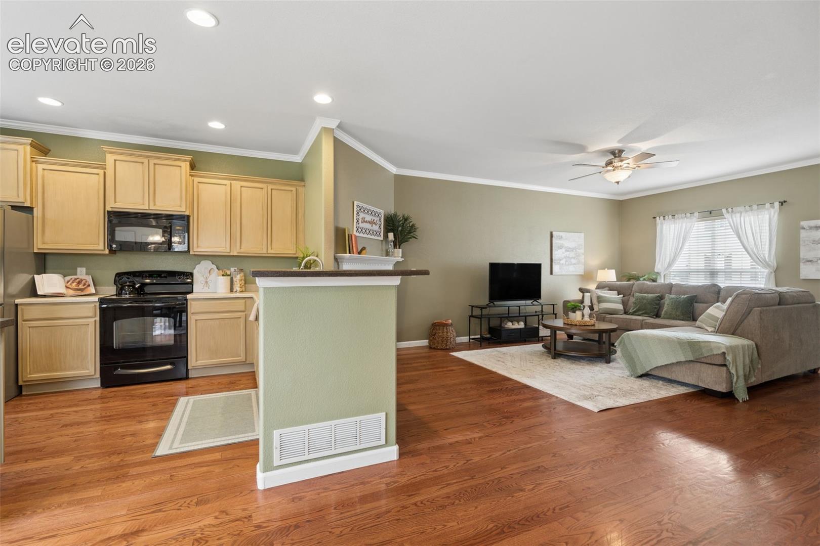 Functional Kitchen with breakfast bar, ample cabinets and pantry