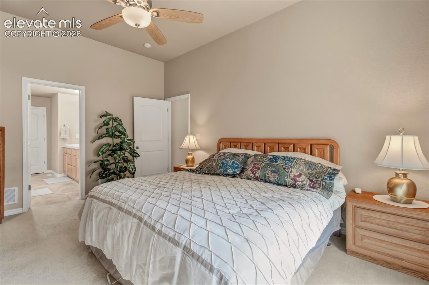 Carpeted flooring with an overhead ceiling fan