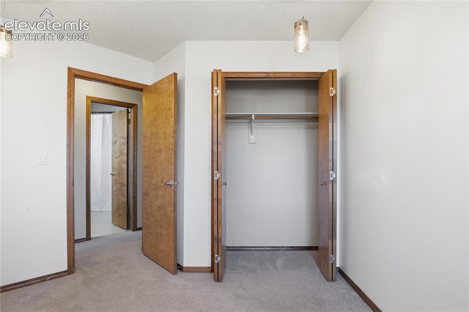 BEDROOM 3 FEATURING AND A CUSTOM MULTI-PENDANT LIGHTING FIXTURE