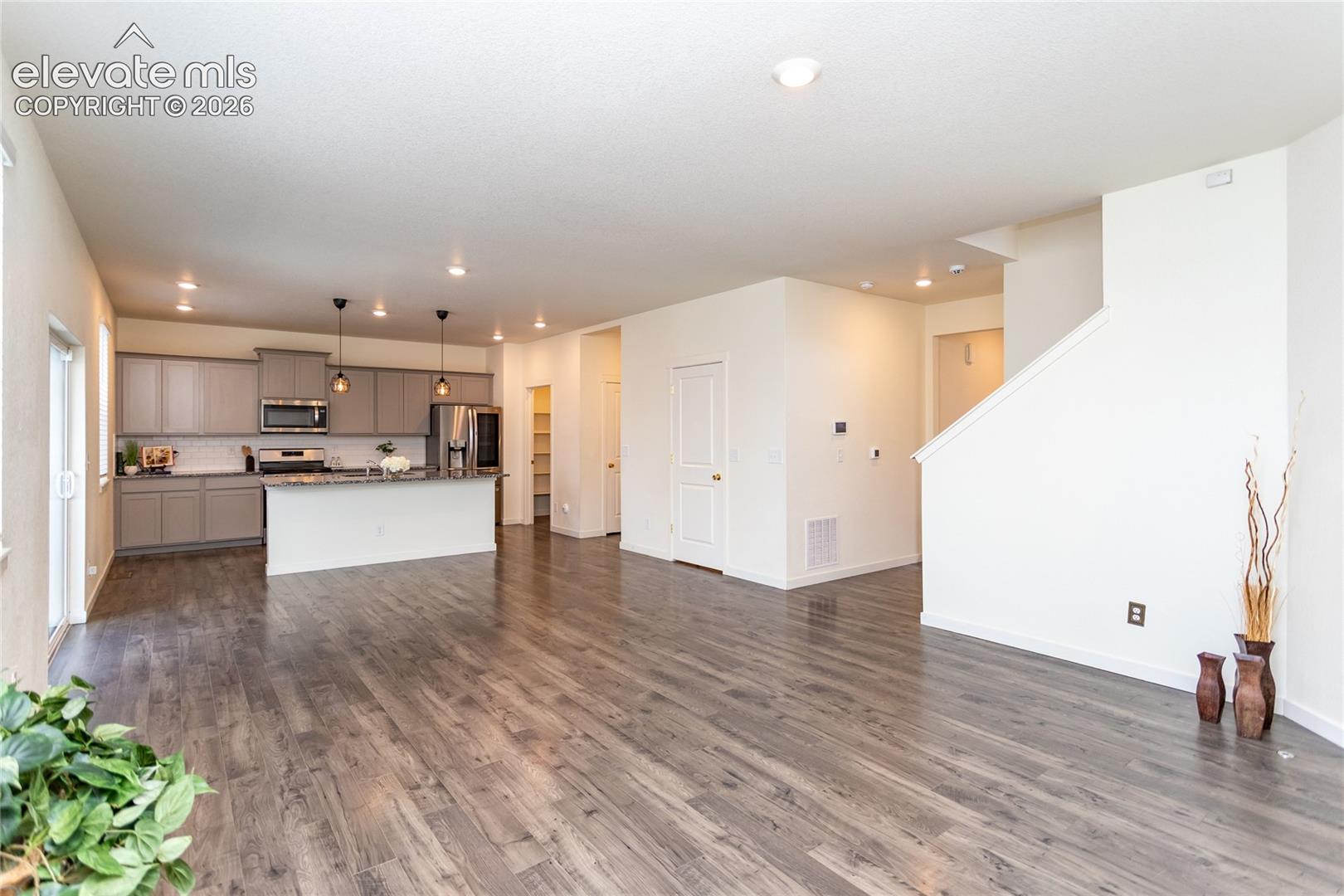 Living room flows into the dining area and the kitchen.