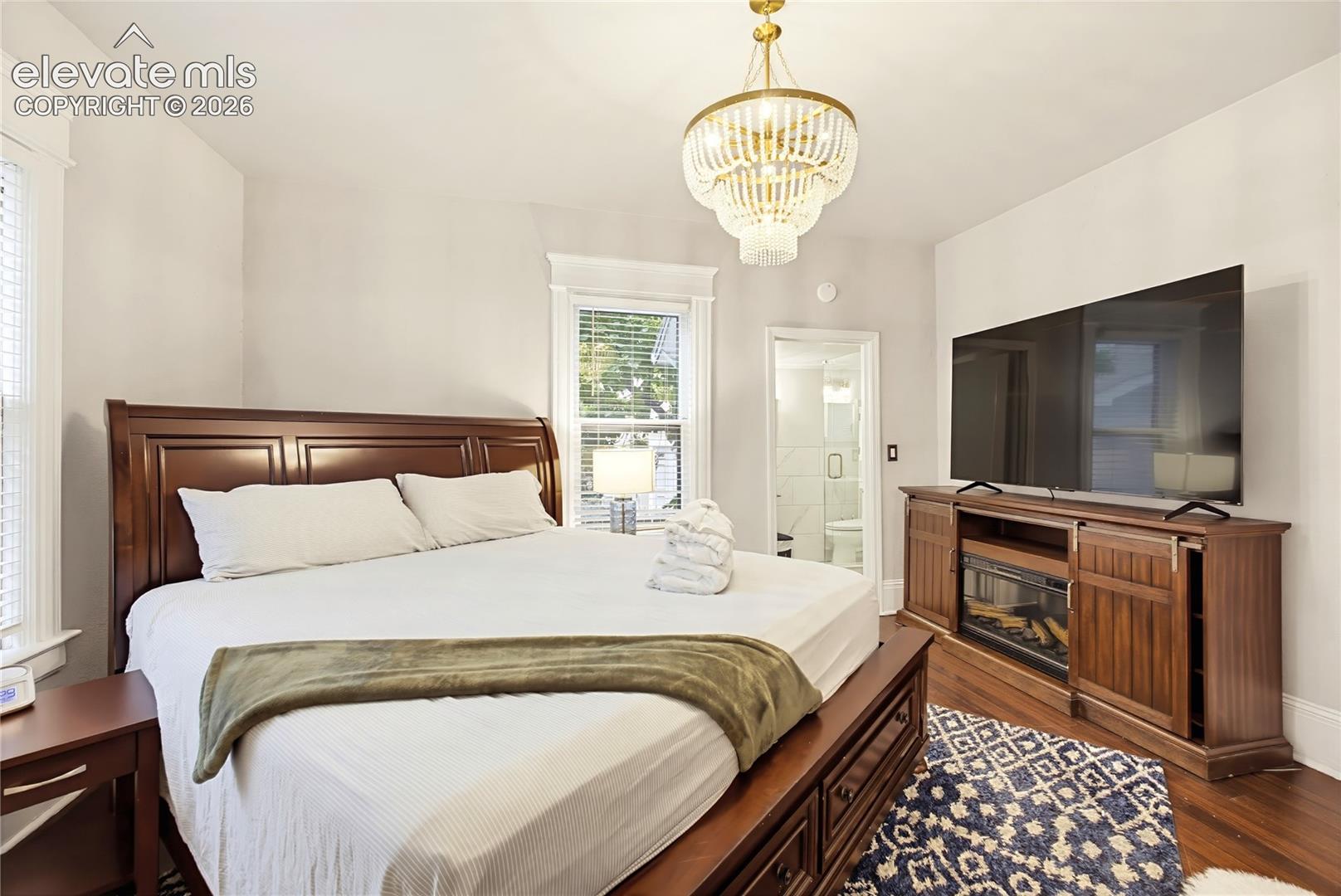 Recessed lighting, wood-finish flooring, and a decorative chandelier