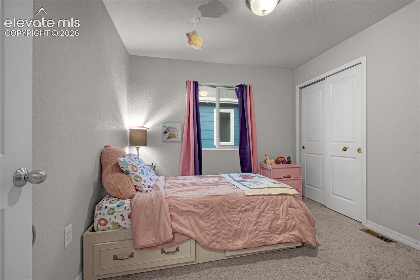 Interior room featuring light gray walls and plush carpeting