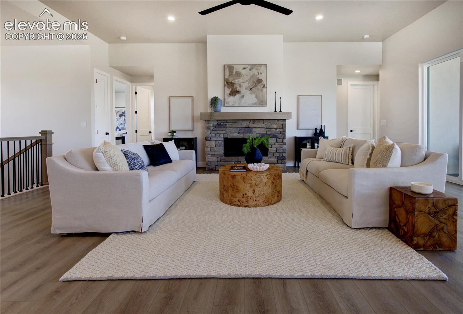 Spacious living area featuring high ceilings and wood-finish flooring