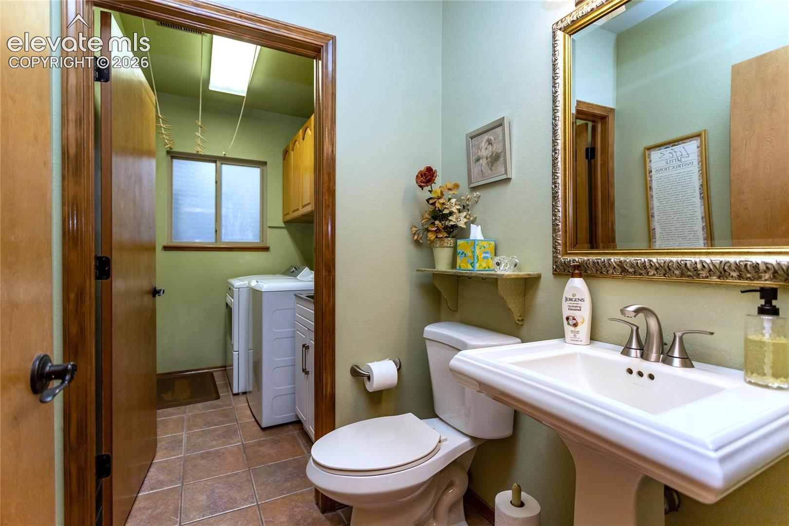 Main Level Piowder Room w/ Adjoining Laundry Room