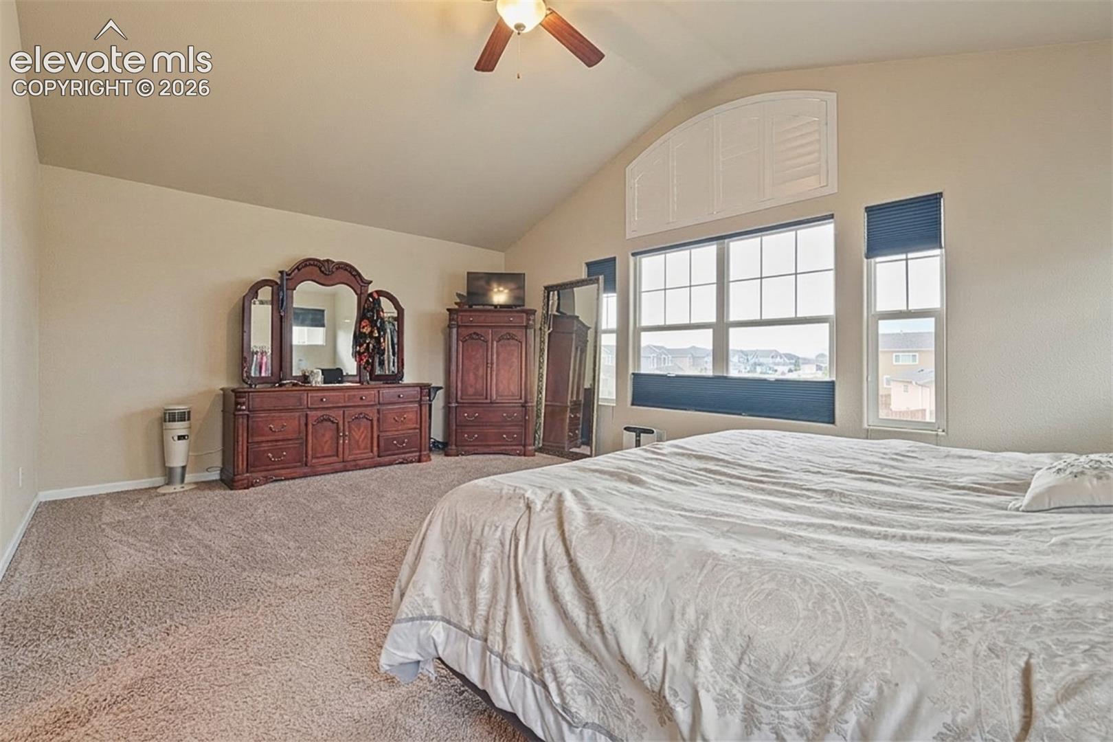 Upper Level: Vaulted ceiling with a ceiling fan and overhead lighting