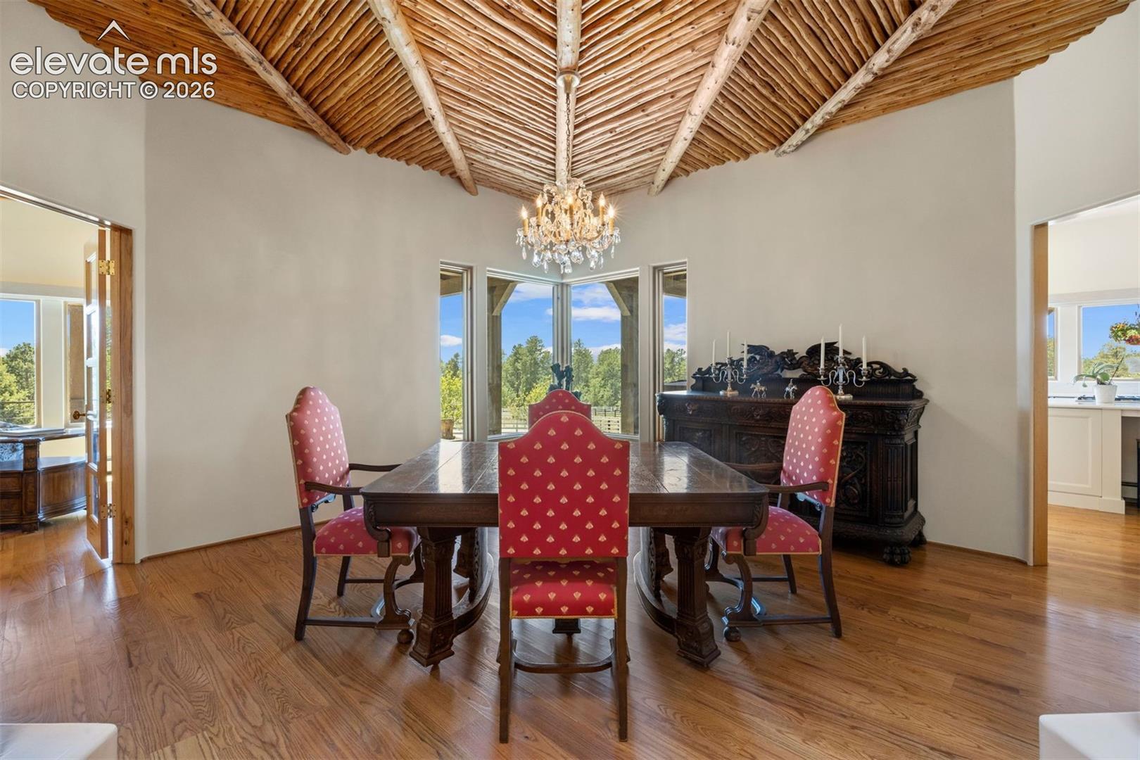 Stunning hand-carved wood columns and a sweeping archway create a dramatic transition from the foyer into the dining room. 