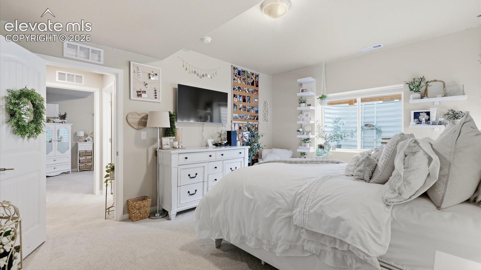 ROOM TO RELAX — Another view showcases the generous size and versatility of this inviting bedroom, perfect for family, guests, or extended stays.