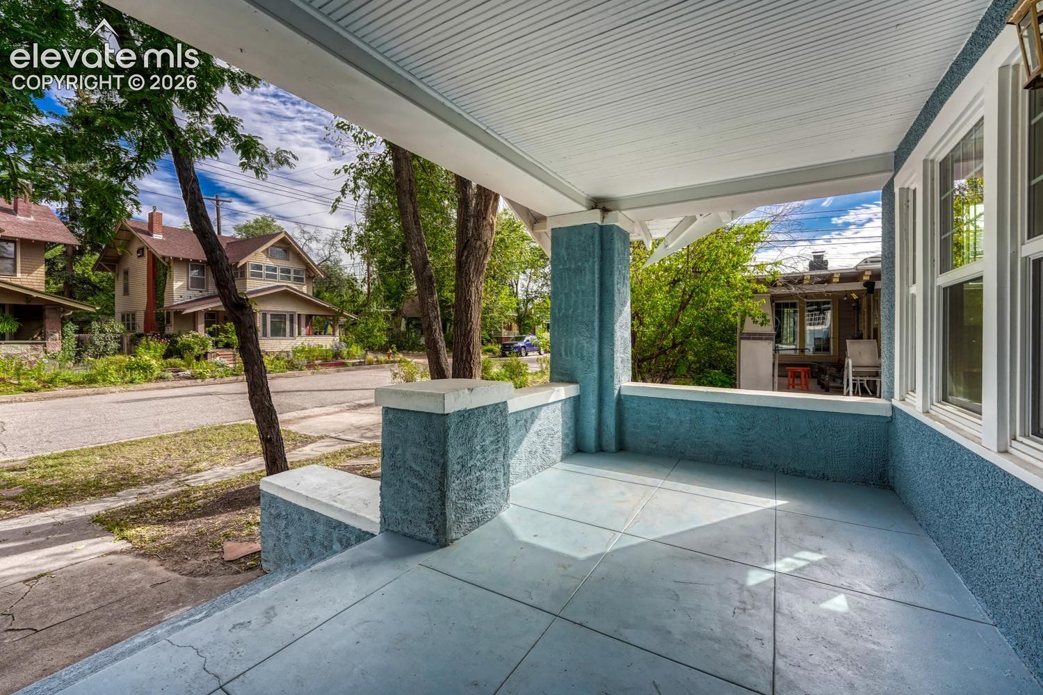 Covered front porch with textured walls and a paneled ceiling