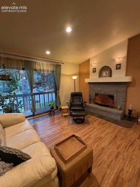 Spacious living area featuring wood-finish flooring and an expansive window with a private balcony
