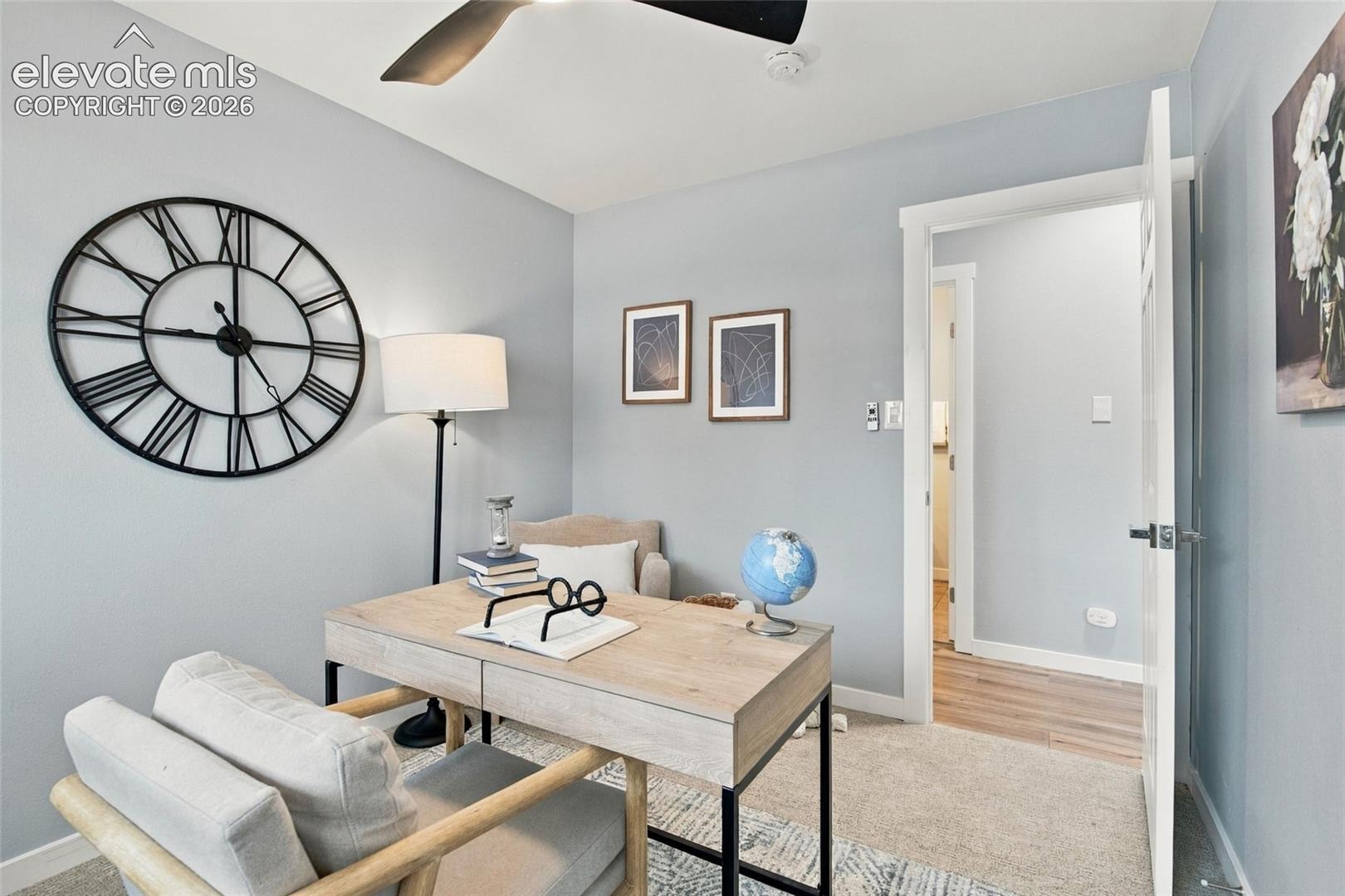 Neutral-toned wall paint, recessed ceiling fan with integrated lighting, and neutral carpeting