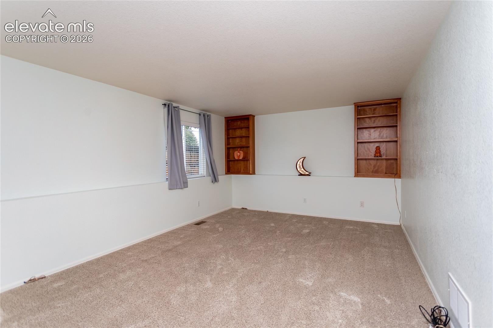 Lower level family room wired for surround sound.  Cherry wood built-in shelving and a recessed display ledge