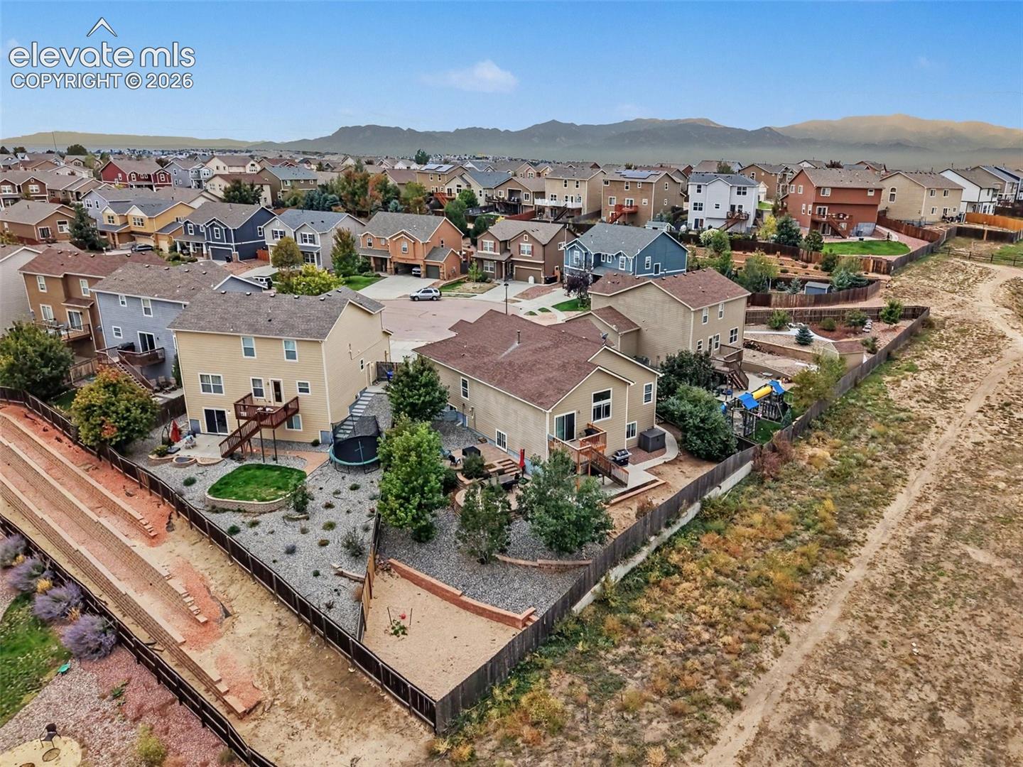 Aerial view of the neighborhood and huge backyard ready for cookouts and relaxing
