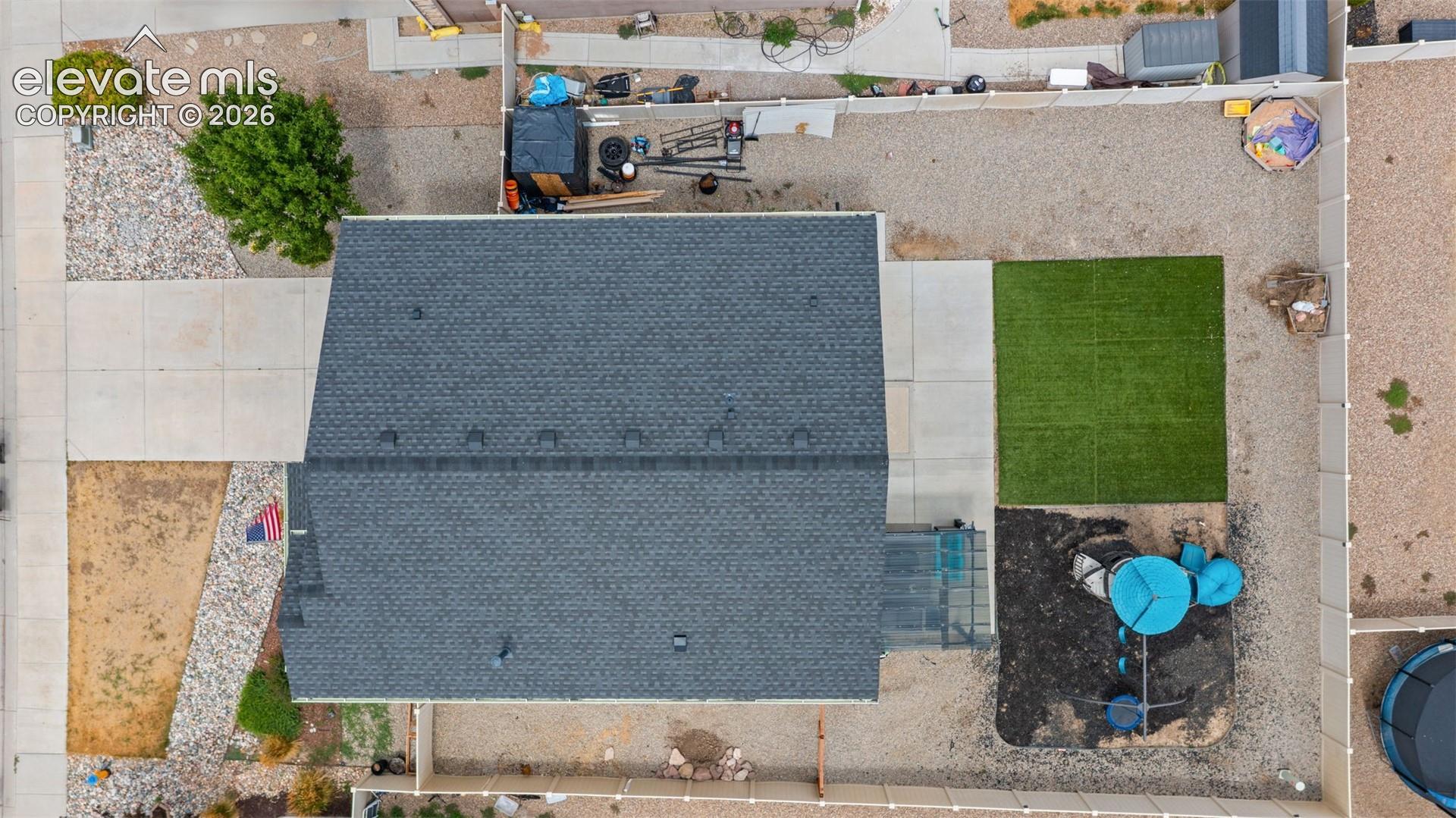 Asphalt shingle roof with a partial concrete driveway