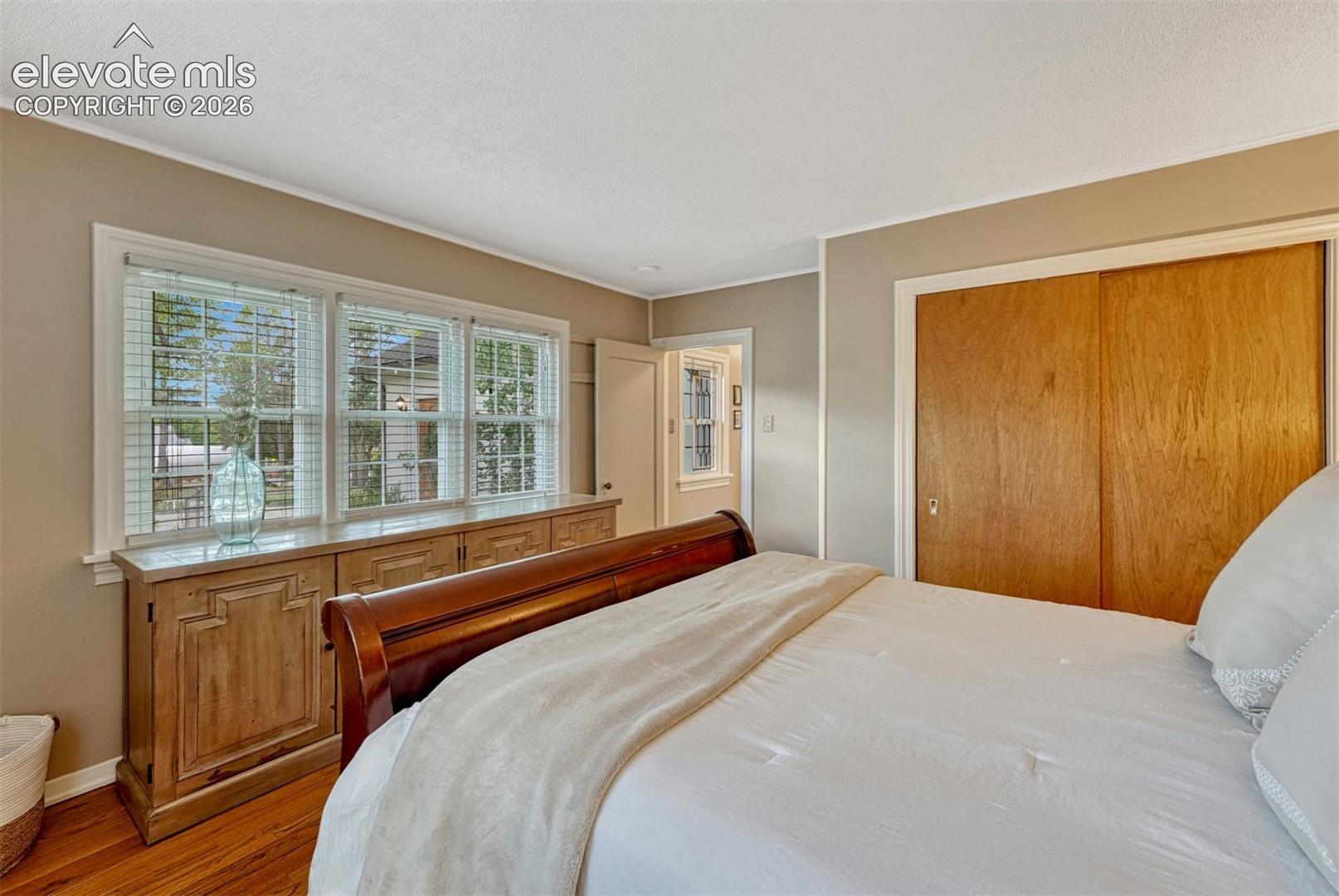 Sun-filled bedroom with wall of windows.