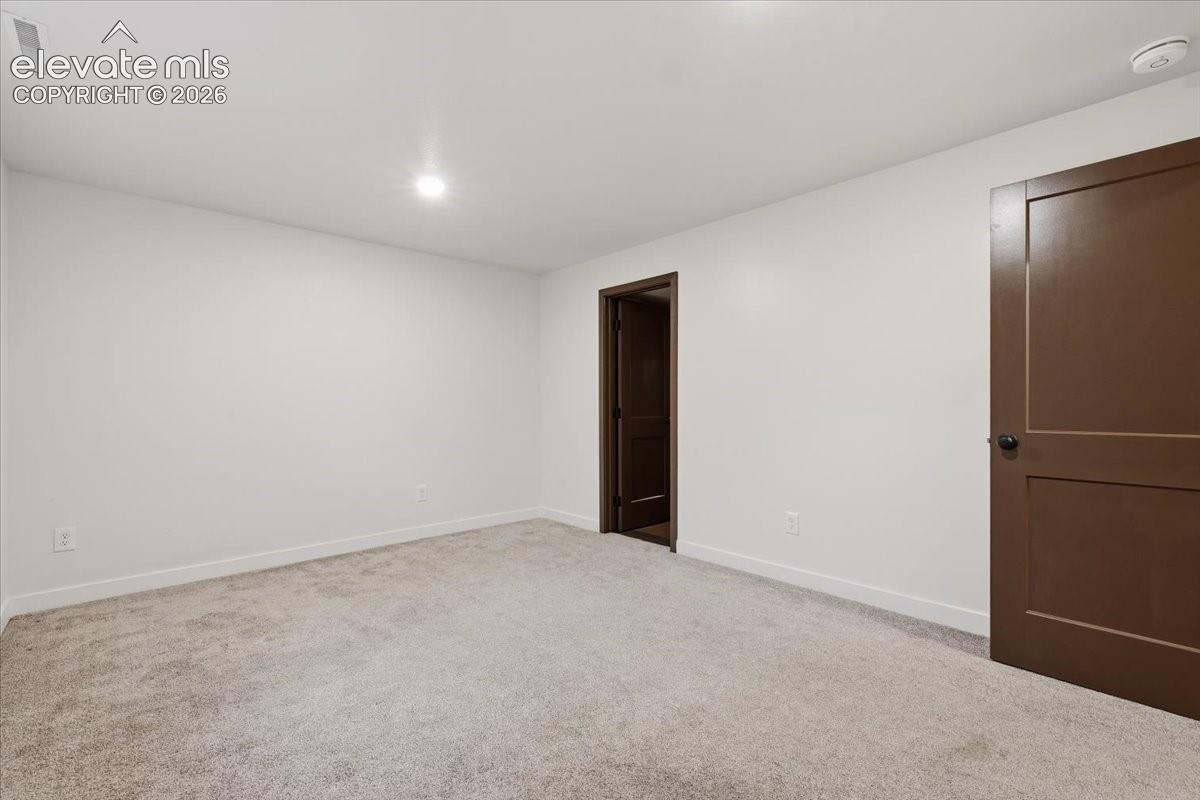 Bedroom 5 - Basement - Neutral tone wall finishes, recessed ceiling lighting and light-toned carpeting