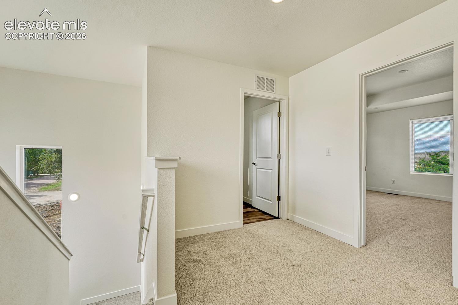 Primary bedroom suite, two bedrooms, full Jack-and-Jill bath, and laundry are all on the upper floor